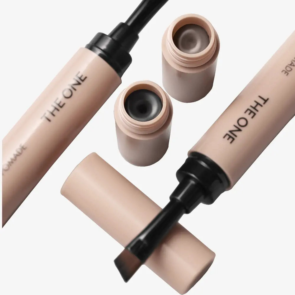Cosmetic concealer bottles with 'THE ONE' branding on a white background
