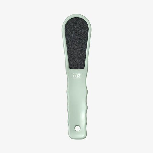 Mint green foot file with black sanding pad on a white background