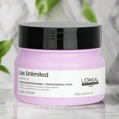 L'Oreal Liss Unlimited hair mask jar on a marble surface with green leaves in the background
