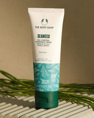 Seaweed oil-control overnight mask tube from The Body Shop on a neutral background with green leaves.