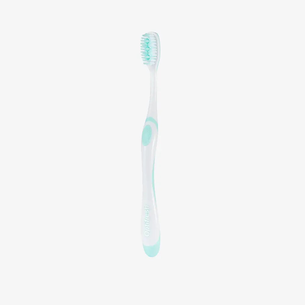 White toothbrush with green accents on a white background