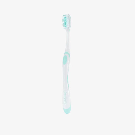 White toothbrush with green accents on a white background