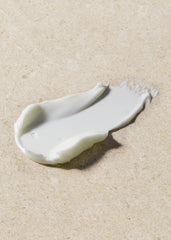 White cream smear on beige sand