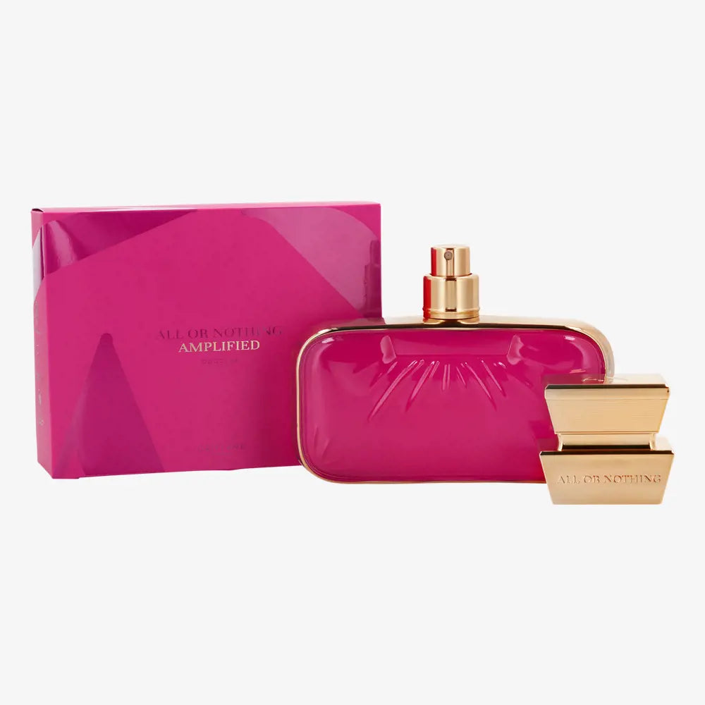 Pink perfume bottle with gold accents and matching box on a white background