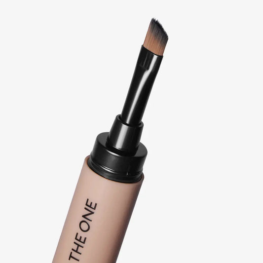Makeup brush with a beige handle labeled 'THE ONE' on a light gray background