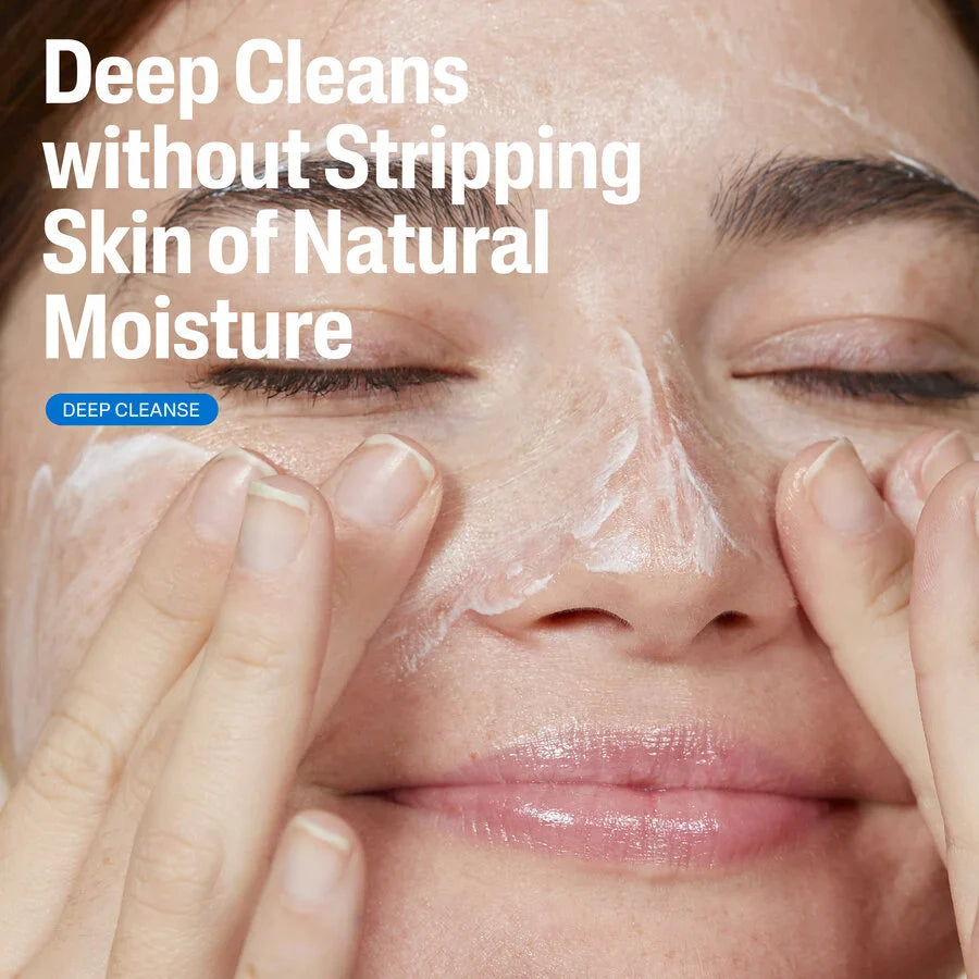 Person applying facial cleanser with text 'Deep Cleans without Stripping Skin of Natural Moisture' on a beige background