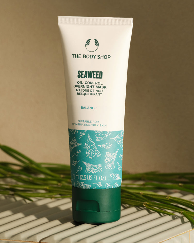 Seaweed oil-control overnight mask tube from The Body Shop on a neutral background with green leaves.