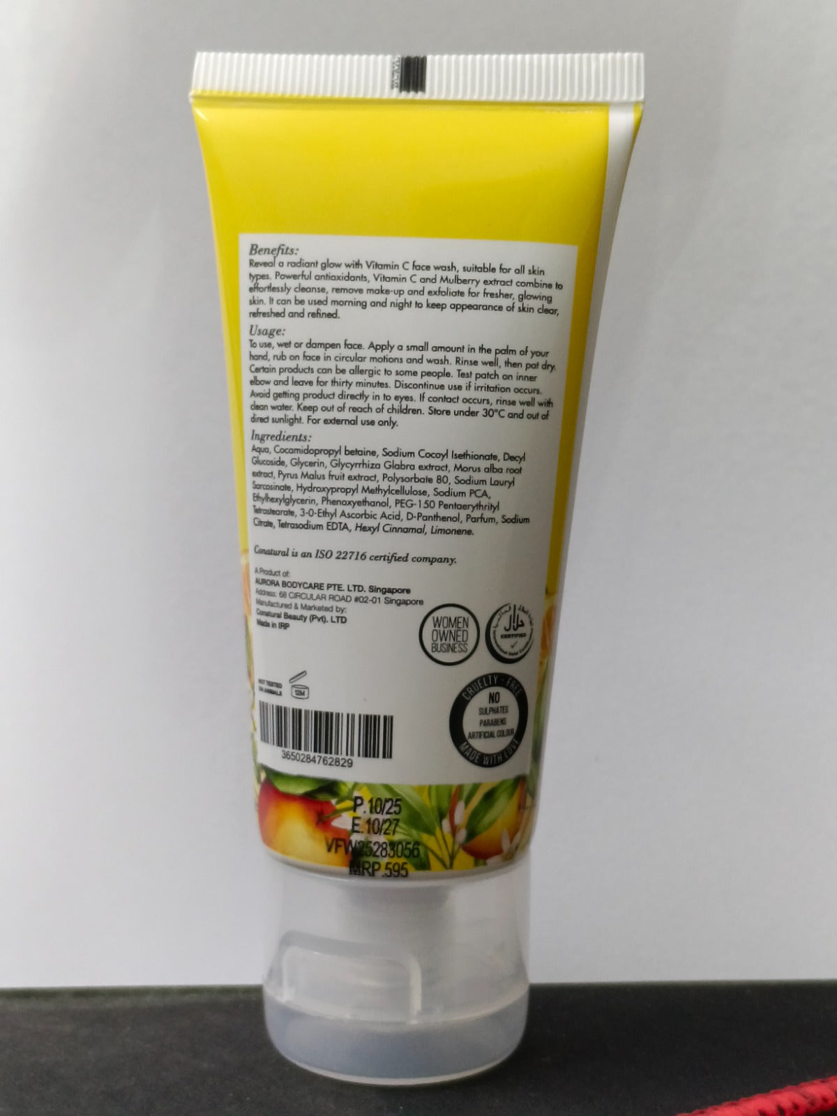 Tube of sunscreen with a yellow label on a gray background